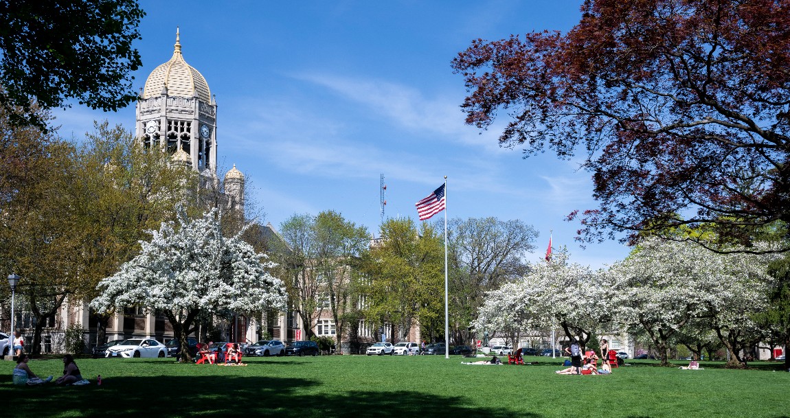 Spring on campus with students on the College Green.